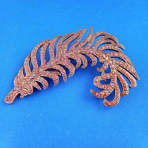 Large feather plume shaped brooch with red rhinestones